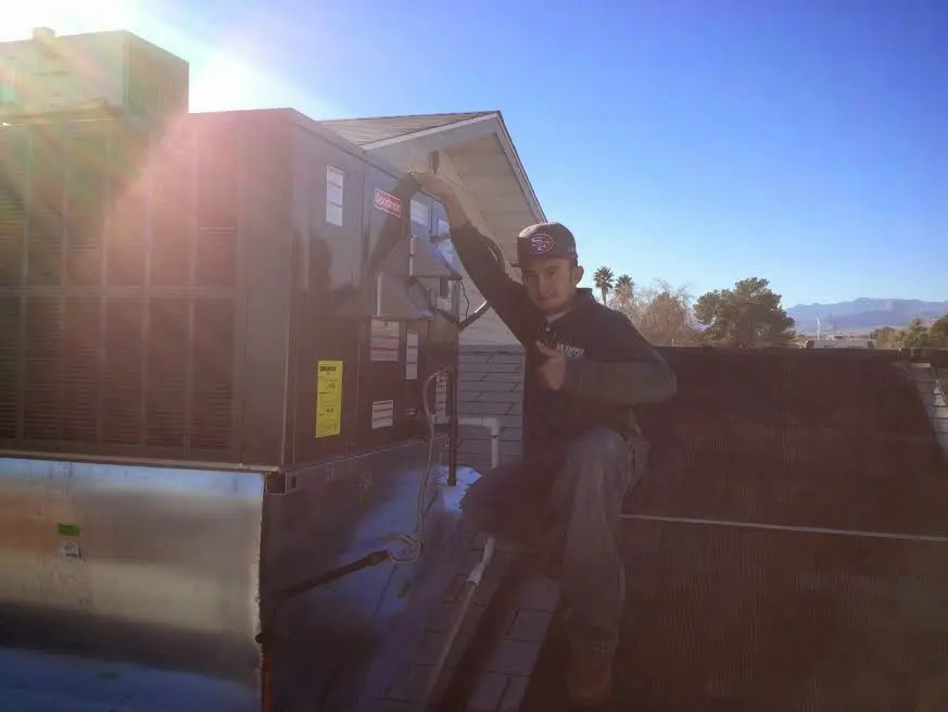 HVAC technician performing Heat Pump Repair on a rooftop unit in Uwchlan